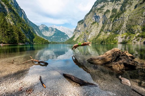 Young man jumps into lake