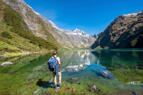 Hiker stands on shore