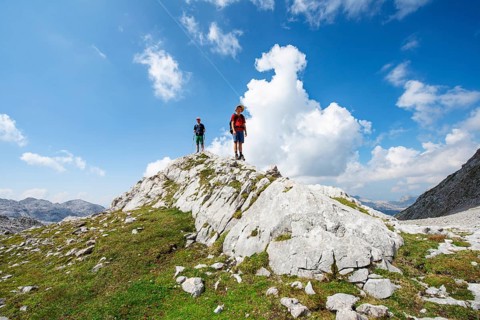 Two hikers standing on a rock