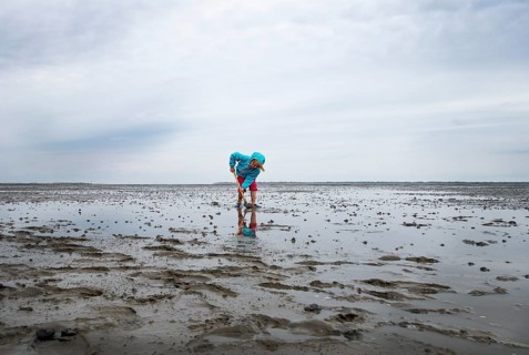 Child playing in the mudflats