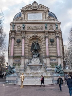 Bronze statue of the fountain La Fontaine Saint Michel at Place Saint-Michel