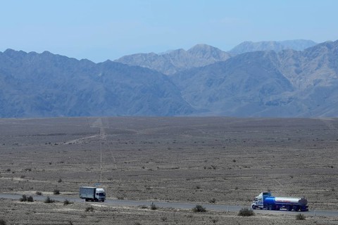 Trucks on the Panamericana drive past the lines of Nasca