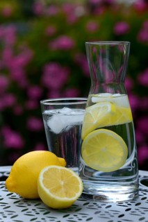 Lemon water in carafe and lemons