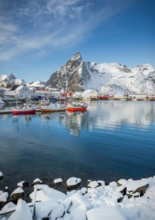 Fishing village with fishermen's cabins and jetty in winter by the fjord