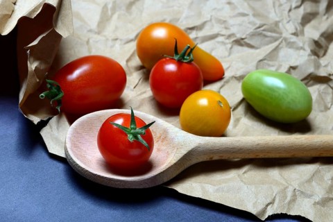 Cherry tomatoes with cooking spoon