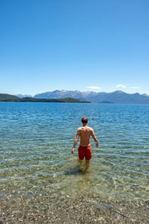 Young man bathes in the lake