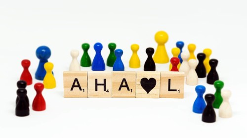 Letter stones with many blurred figures in a small space