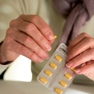Woman holding medication pill