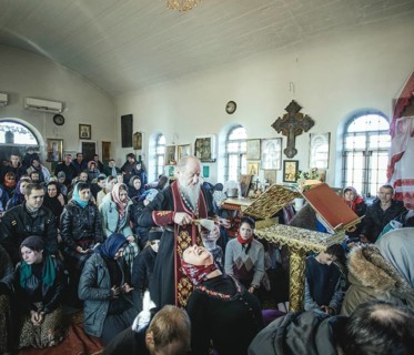 Father Sergei during an exorcism in his church in Ochamchira