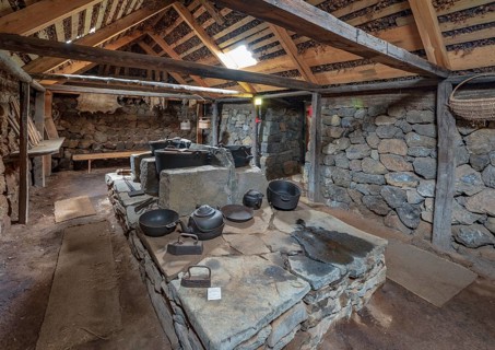 Interior view of pots and pans on an old fireplace in the back Hides on peat farm