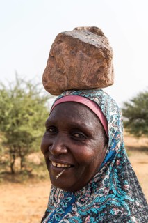 Woman with a stone on her head