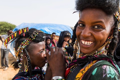 Two girls sharing a waterbag