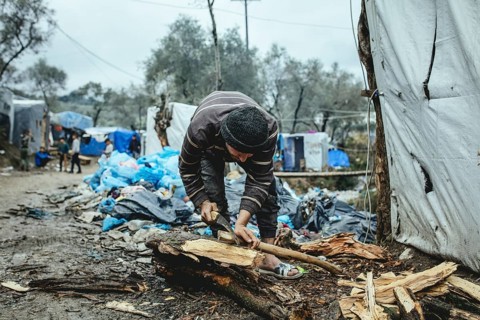 Fugitive in camp chopping firewood