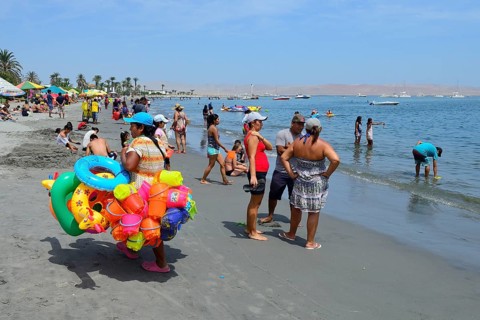 Beach saleswoman with colorful swimming tires and sand toys