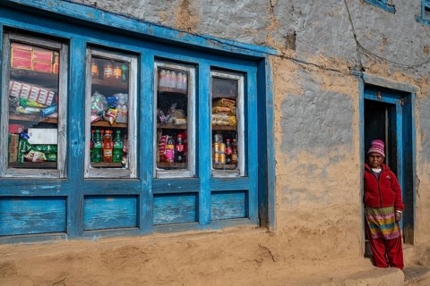 A local woman standing in the doorway of her shop