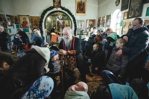 Father Sergei during an exorcism in his church in Ochamchira