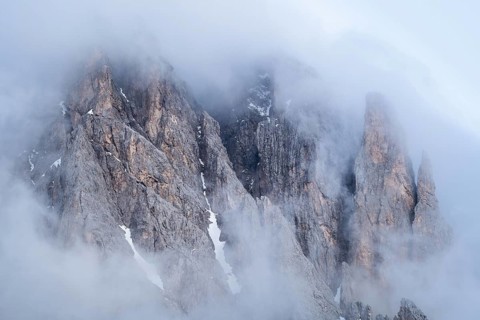 Rock face framed by clouds
