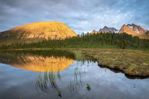 Mountains of the Lyngen Alps are reflected in the lake