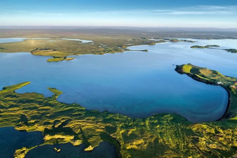 Aerial view of coast with green pseudo-craters