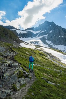 Hikers in front of snow-covered mountains