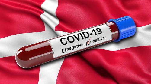Flag of Denmark waving in the wind with a positive Covid-19 blood test tube. 3D illustration