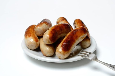 Chipolata sausages on plate
