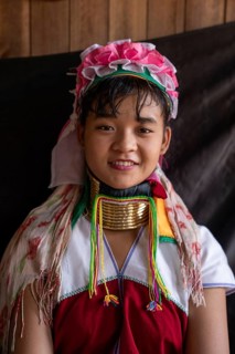 Young long necked woman with several brass rings around her neck