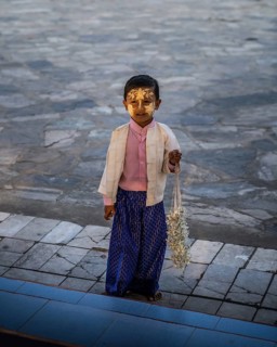 Small boy with yellow face painting