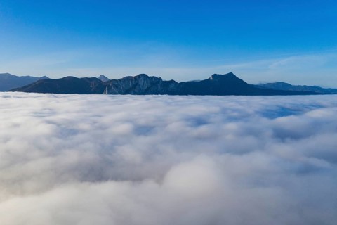 Dragon wall and sheds rising out of the sea of fog