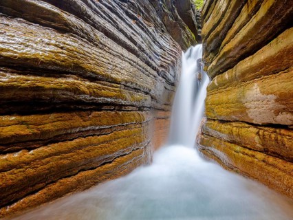 The Taugl or Tauglbach flows through the red gorge