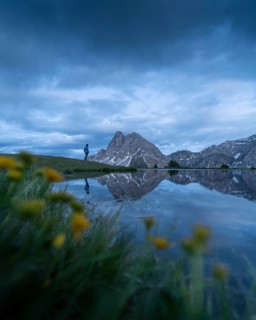 Peitlerkofel with reflection in small lake and flowers
