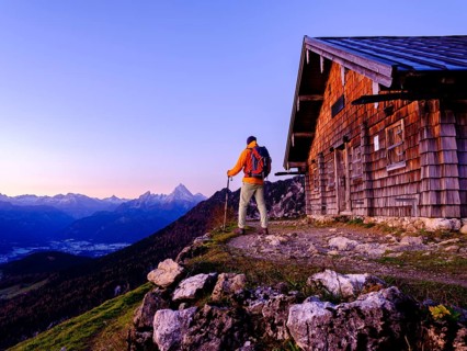 Mountaineer at the Scheibenkaser Almhuette in the morning light
