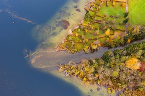 River delta of the Wangauer Ache into the Mondsee with autumnally discoloured mixed forest