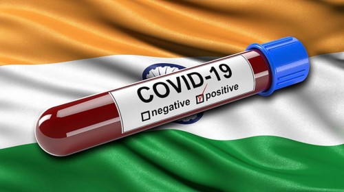 Flag of India waving in the wind with a positive Covid-19 blood test tube. 3D illustration