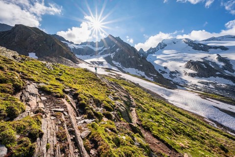 Hikers in front of snow-covered mountains
