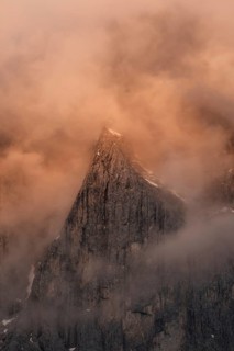 Rock face framed by clouds at sunset