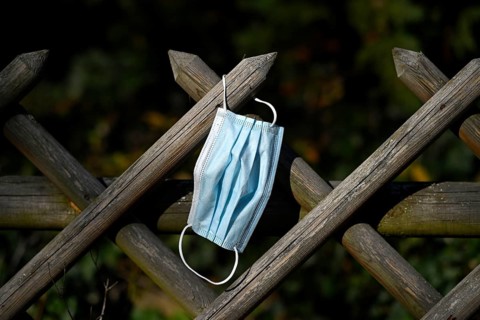 Lost face mask hangs on hunter's fence