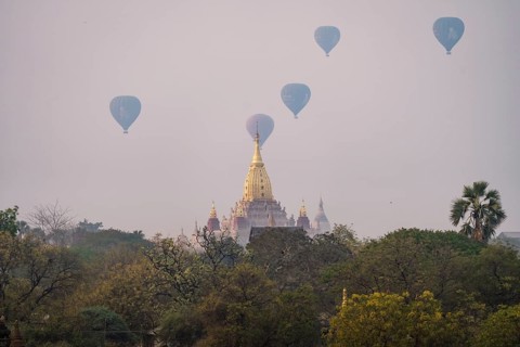 Ananda temple with several colorful balloons