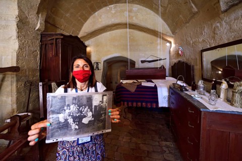 City guide shows old photographs at the Casa Grotta Museum