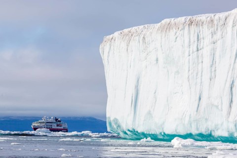 Cruise ship behind iceberg