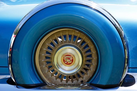 Cadillac emblem in the rim of the spare tyre at the rear of a 1956 Cadillac Eldorado classic car