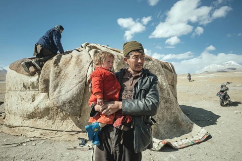 Man carrying child in his arms
