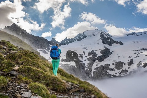Hiking in front of snow-covered mountain peaks