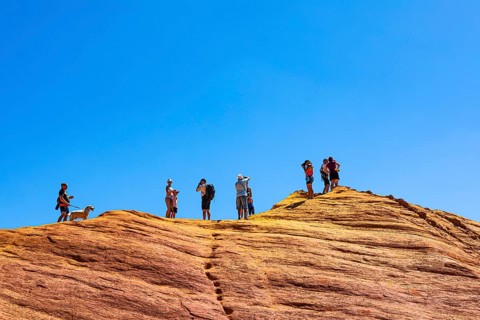 Tourists on the top of an ochre cliff