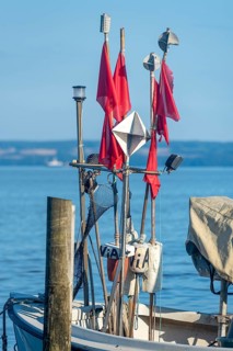 Fishing boat with red flags