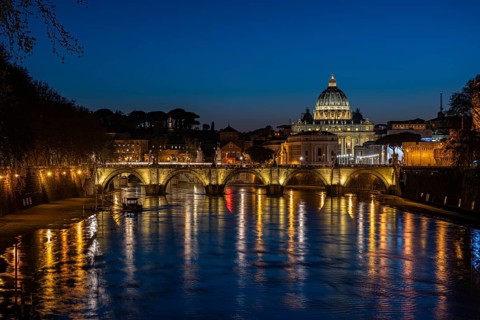 View over the Tiber at evening light on Ponte Sant`Angelo and St. Peter's Basilica