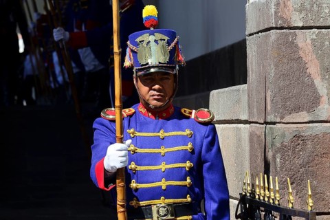 Guard in colourful uniform in front of the seat of government Palacio de Carondelet