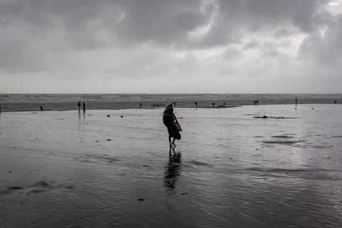 Bathers on the beach from Cox's Bazaar to monsoon rain