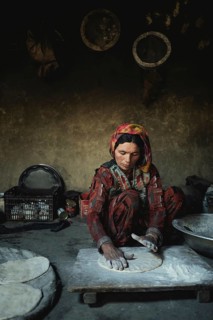 A woman bakes flat bread