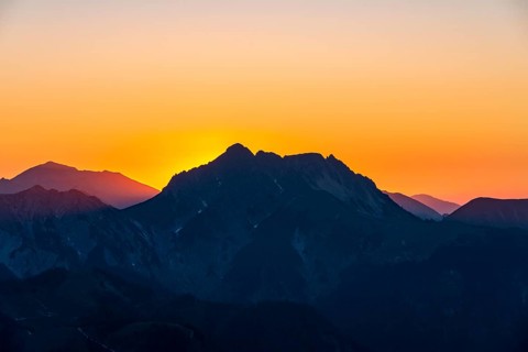 Sunset behind mountain silhouette